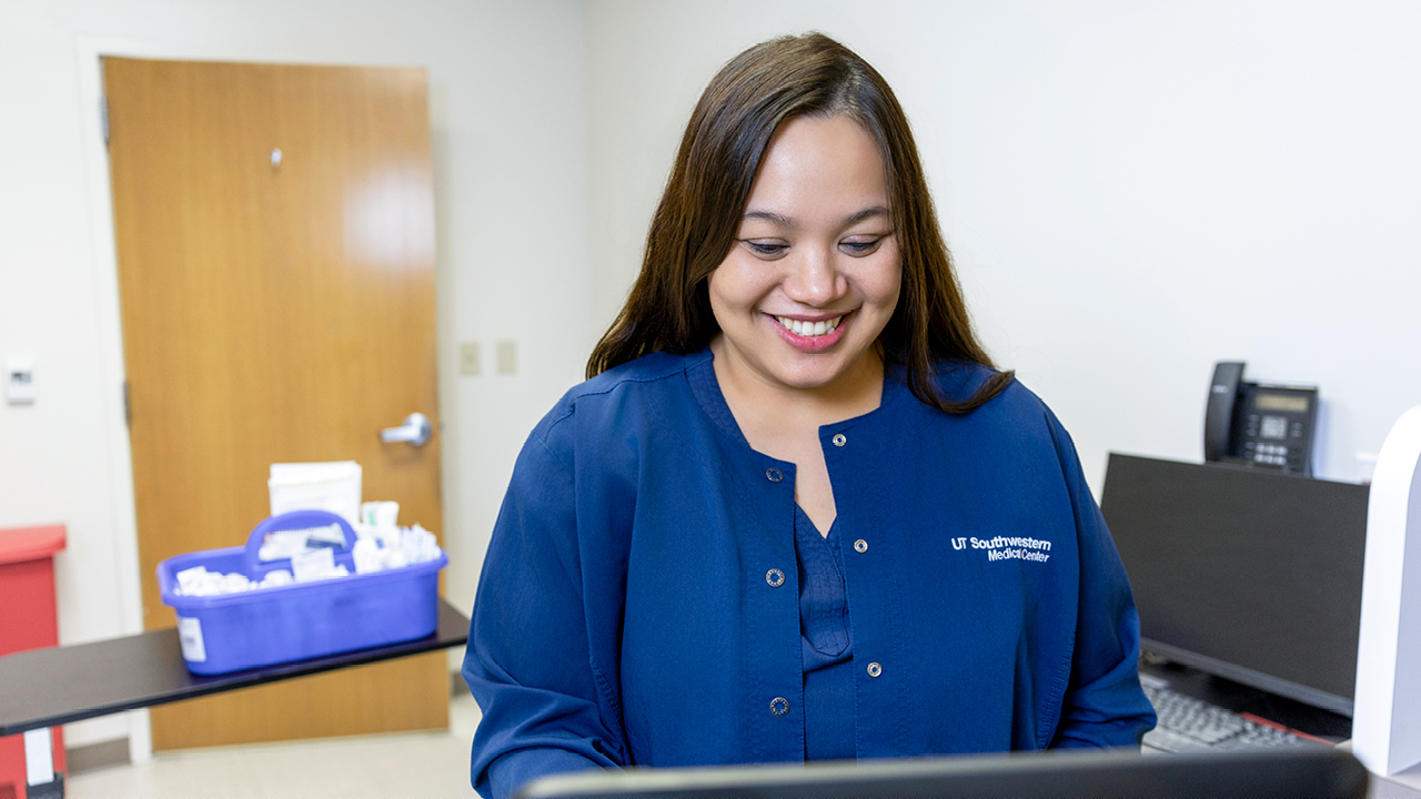 Smiling nurse at computer monitor