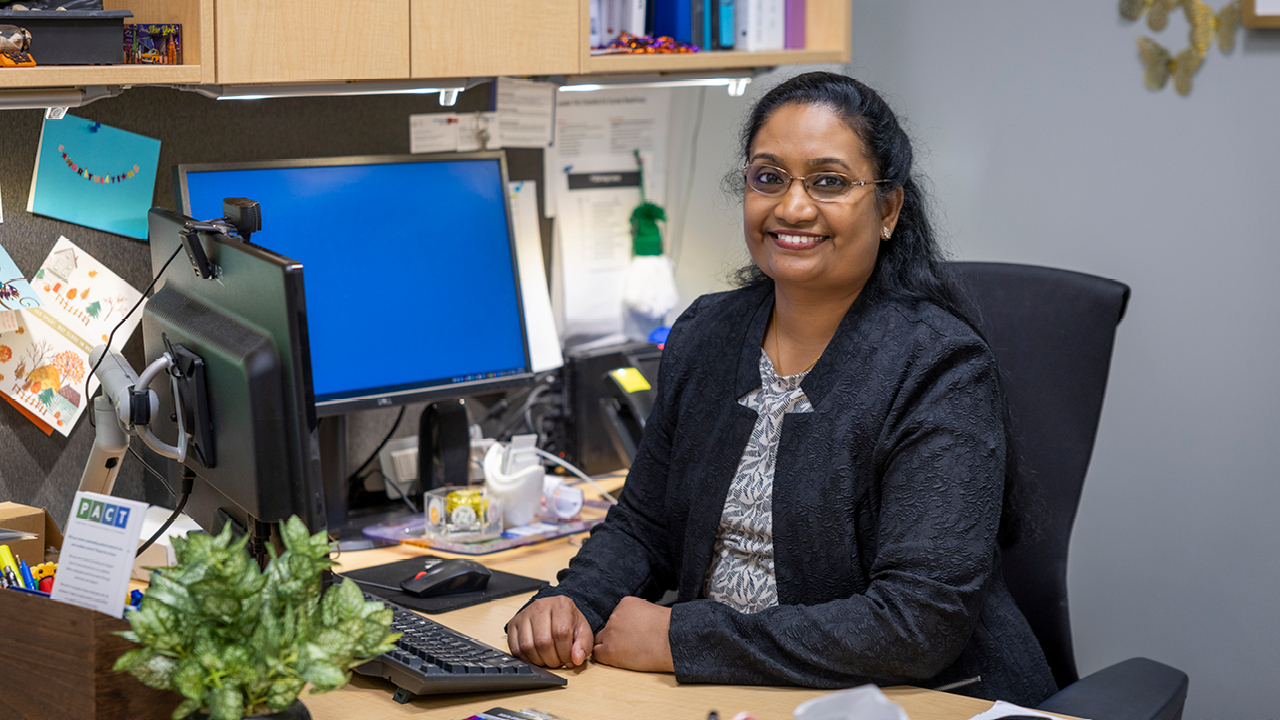 Smiling nurse sitting at desk